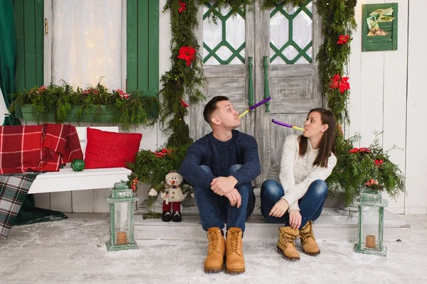 Happy beautiful young couple in love dressed in sweater sitting — Stock Photo, Image