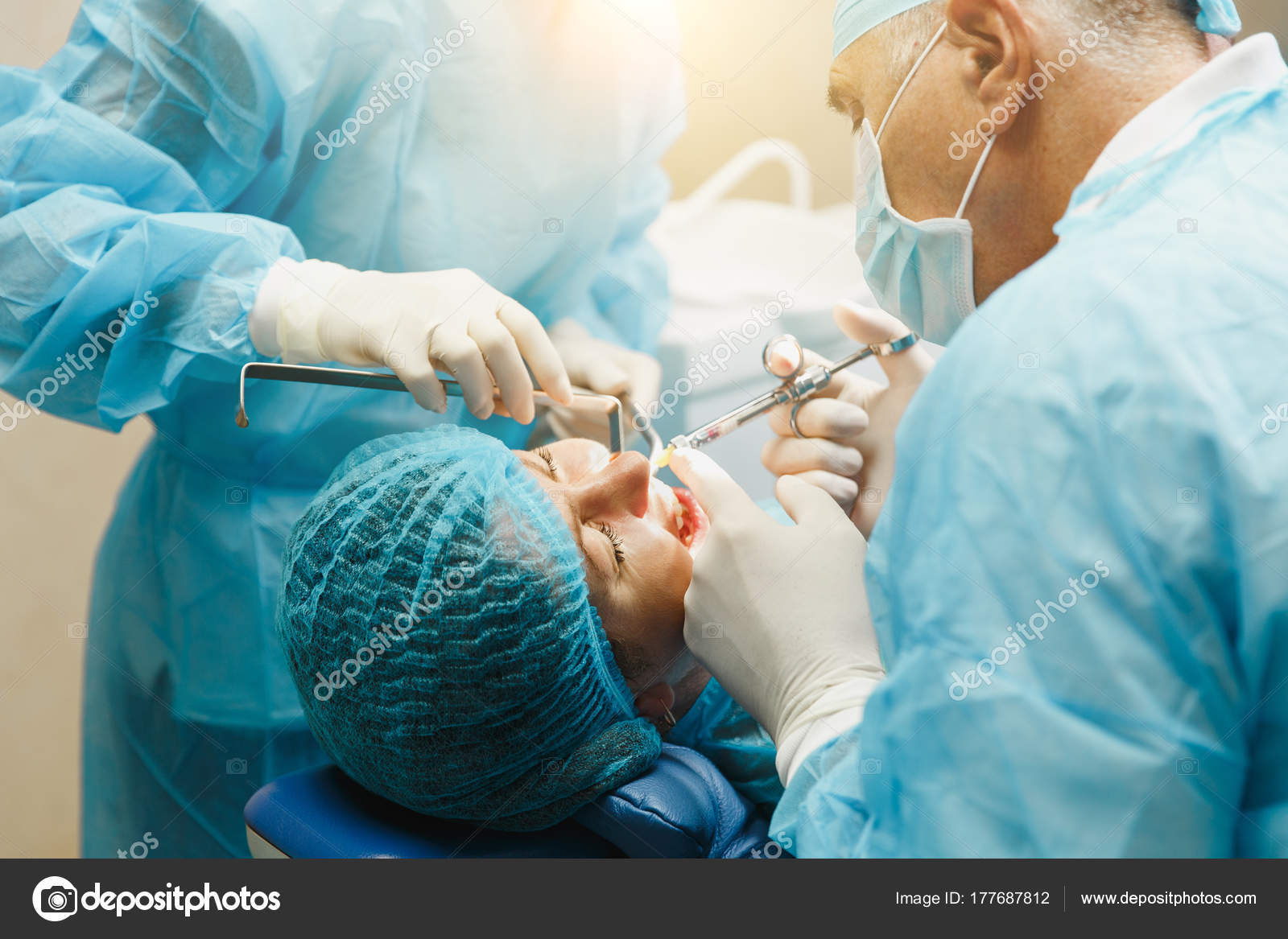 Male old professional dentist surgeon in uniform and female assistant