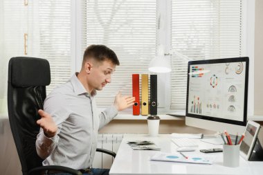 Masada oturan gömlek şok ve çapraşık iş adamı 