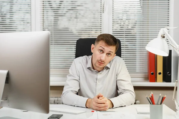 Çapraşık şok ve bilgisayarda çalışan modern monitör, klasörler, lamba, belge penceresi arka plan üzerinde ışık Office ile iş adamı masa başında oturan gömlek stres. Yöneticisi veya alt.