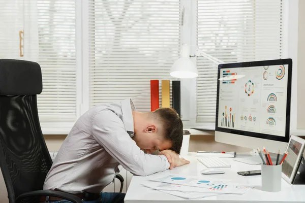 Serious moe en stress zakenman in shirt zit op de — Stockfoto