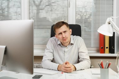 Çapraşık şok ve bilgisayarda çalışan modern monitör, klasörler, lamba, belge penceresi arka plan üzerinde ışık Office ile iş adamı masa başında oturan gömlek stres. Yöneticisi veya alt.