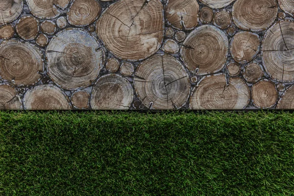 Texture of wooden log houses, grass green, tree stumps or stone background for design and decoration.
