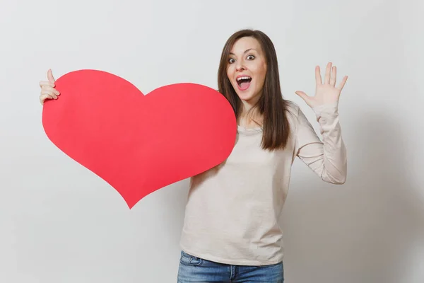 Beautiful young smiling woman holding big red heart in hands isolated on white background. Copy space for advertisement. With place for text. St. Valentine's Day or International Women's Day concept. — Stock Photo, Image