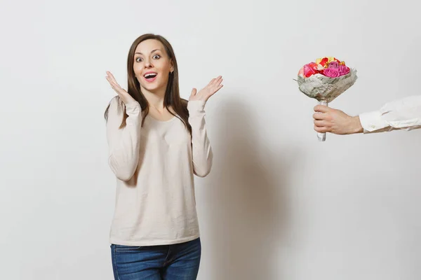 Delight woman, man hand aside with bouquet of beautiful roses flowers isolated on white background. Copy space for advertisement. St. Valentine's Day, International Women Day birthday holiday concept.