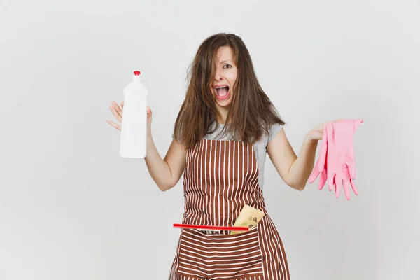 Young fun crazy dizzy loony wild screaming housewife tousled hair, in apron squeegee cleaning rag in pocket isolated on white background. Mad woman, bottle with cleaner liquid, pink gloves. Copy space — Stock Photo, Image