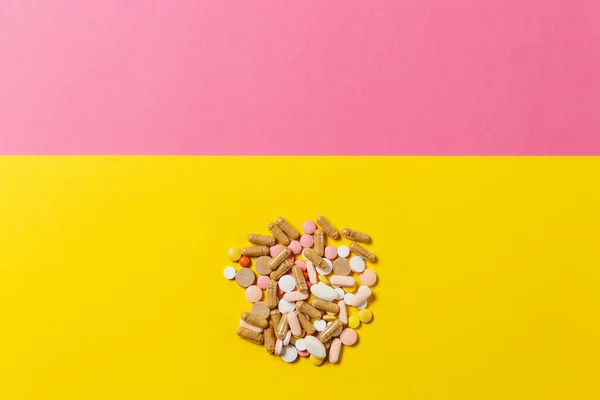 Medicinering vit färgglada runda tabletter ordnade abstrakt på gul rosa färgbakgrund. Acetylsalicylsyra kapsel piller för design. Hälsokoncept behandling val hälsosam livsstil. Kopiera utrymme annons — Stockfoto