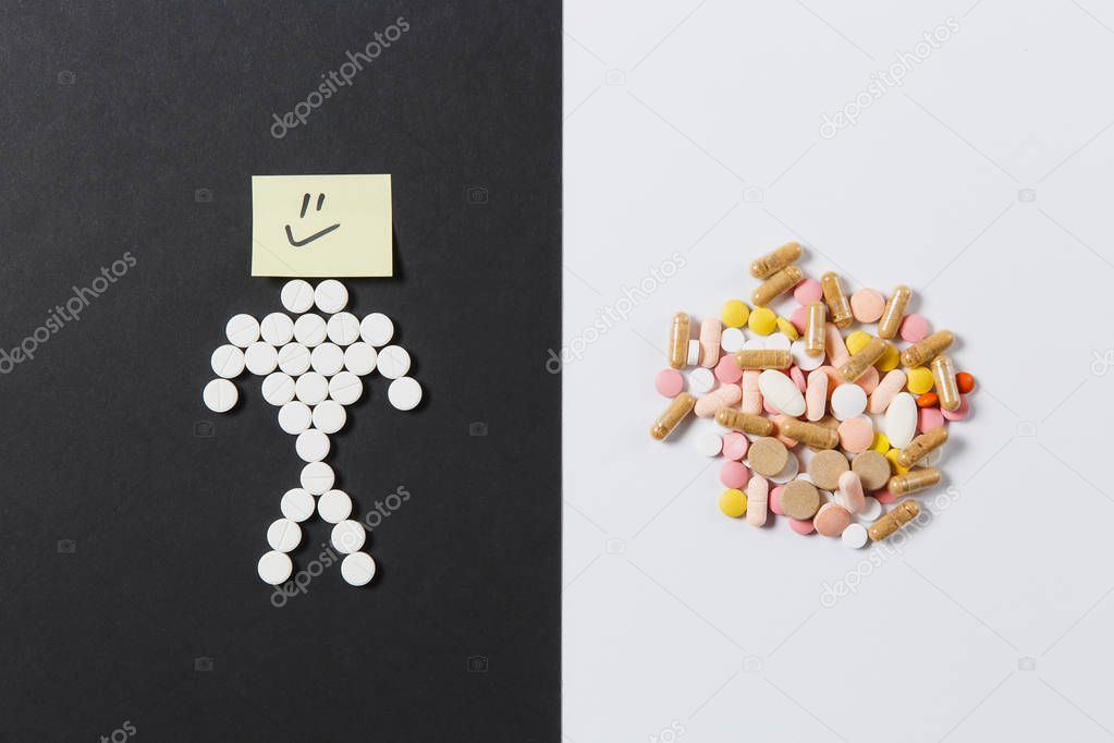 Medication white colorful round tablets arranged abstract on white black background. Human smile, aspirin, capsule pills design. Treatment choice healthy lifestyle concept. Copy space advertisement.