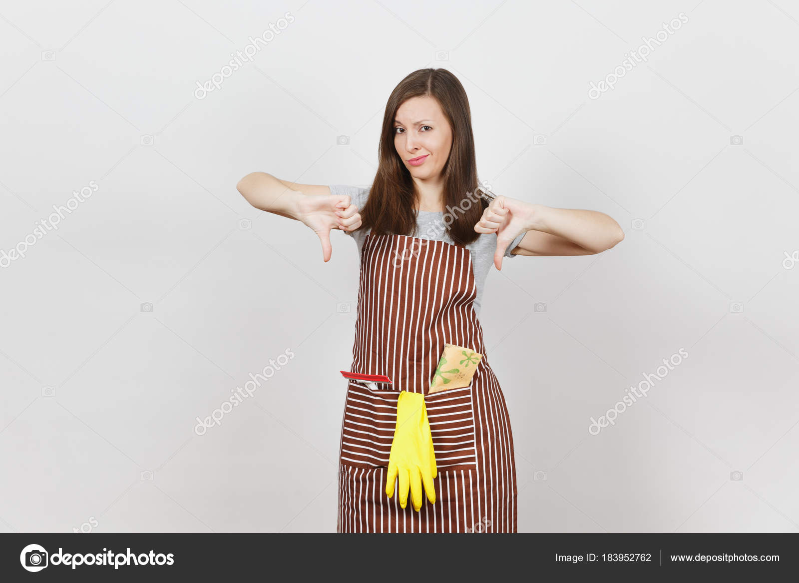 Young sad upset tired crying housewife in striped apron with cleaning