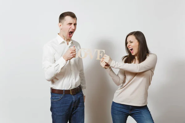 Young couple in love. Man and woman with wooden word Love isolated on white background. St. Valentine's Day International Women's Day birthday holiday concept. Quarrel divorce break up of relationship — Stock Photo, Image