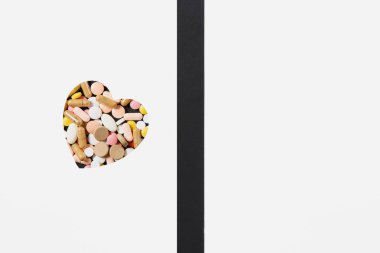 İlaç beyaz renkli yuvarlak tablet kalp beyaz siyah arka plan üzerine soyut düzenlenmiştir. Aspirin, kapsül tasarım hap. Tedavi, sağlıklı yaşam kavramı. Kopya alanı reklam için.