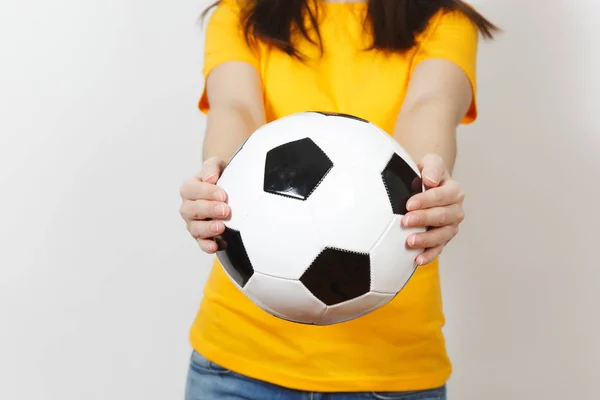 Close up cropped portrait European young woman, football fan or player in yellow uniform holding soccer ball isolated on white background. Sport, play football, health, healthy lifestyle concept.