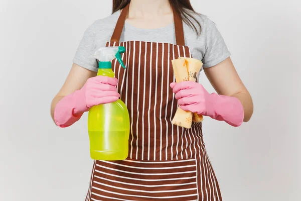 Close up cropped portrait housewife in pink gloves, striped apron isolated on white background. Woman holding spray bottle with cleaner liquid for cleanup, cleaning rag. Copy space for advertisement. — Stock Photo, Image