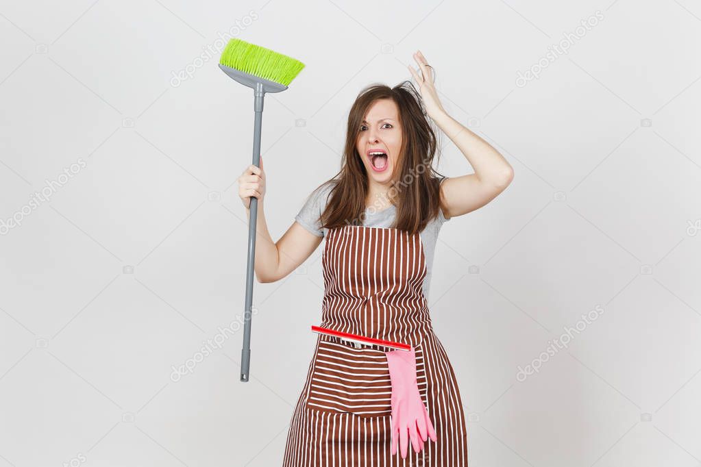 Young fun crazy dizzy loony wild screaming housewife tousled hair in striped apron squeegee pink gloves in pocket isolated on white background. Mad witch woman with broom. Copy space for advertisement