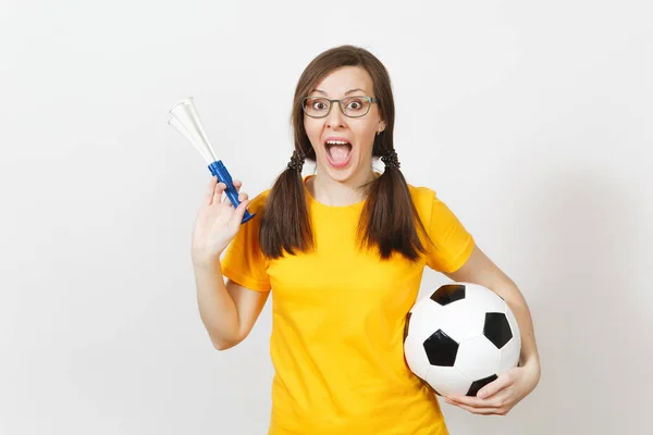 Smiling European woman, two fun pony tails, football fan or player in glasses, yellow uniform hold football pipe, ball isolated on white background. Sport, football, health, healthy lifestyle concept. — Stock Photo, Image