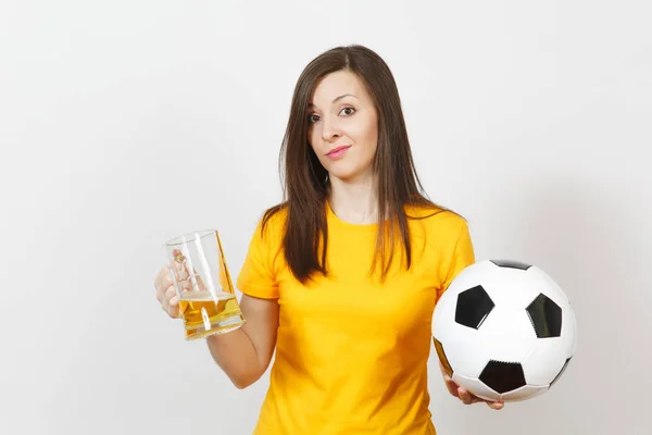 Pretty European young sad upset woman, football fan or player in yellow uniform holds pint mug of beer, worries about losing team isolated on white background. Sport, play football, lifestyle concept.