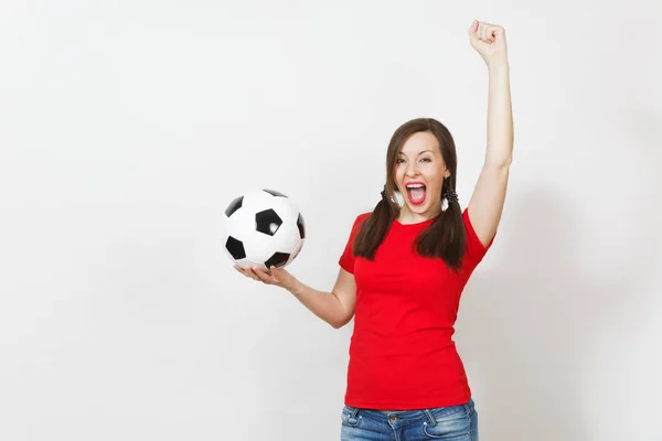 Overjoyed European young woman, two fun pony tails, football fan or player in red uniform holding classic soccer ball isolated on white background. Sport football health, healthy lifestyle concept. — Stock Photo, Image