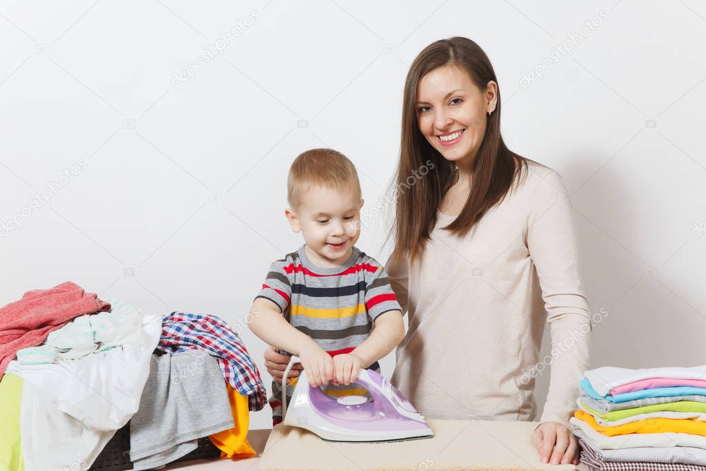 Little boy, woman ironing family clothing on ironing board with iron. Son help mother with housework isolated on white background. Encouraging Autonomy in children concept. Parenthood, child concept.