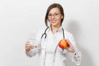 Smiling beautiful doctor woman with stethoscope, glasses isolated on white background. Female doctor in medical gown holding glass of water, red apple. Healthcare personnel, health, medicine concept. clipart