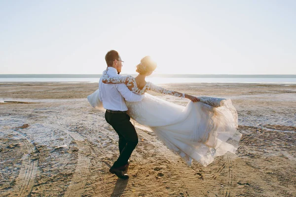 Beautiful wedding photosession. The groom in black trousers and — Stock Photo, Image