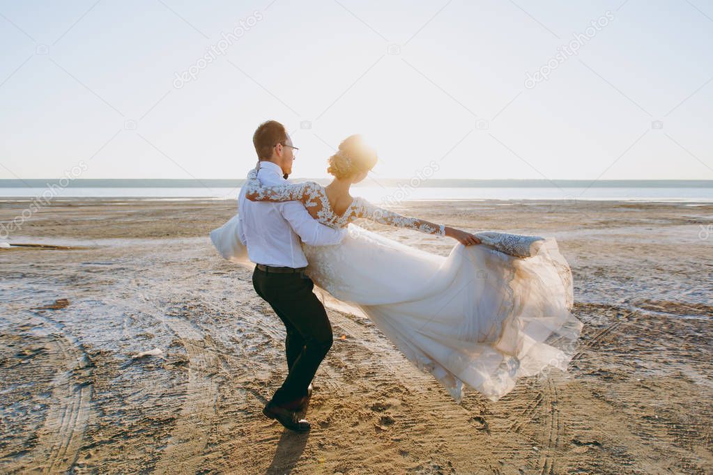 Beautiful wedding photosession. The groom in black trousers and 