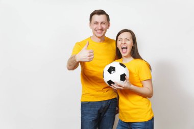 Eğlenceli deli neşeli duygusal genç çift, kadın, erkek, futbol taraftarları destek ekibi ile futbol topu beyaz arka plan üzerinde izole sarı üniforma neşelen. Spor, Aile Eğlence, yaşam kavramı.