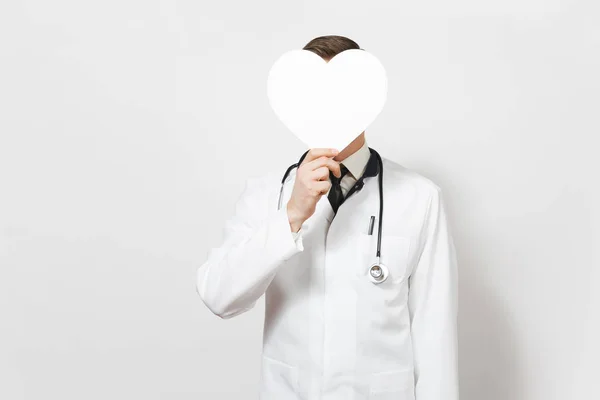 Fun young doctor man isolated on white background. Male doctor in medical uniform, stethoscope holding in front face white figure heart with copy space. Healthcare personnel, health, medicine concept. — Stock Photo, Image