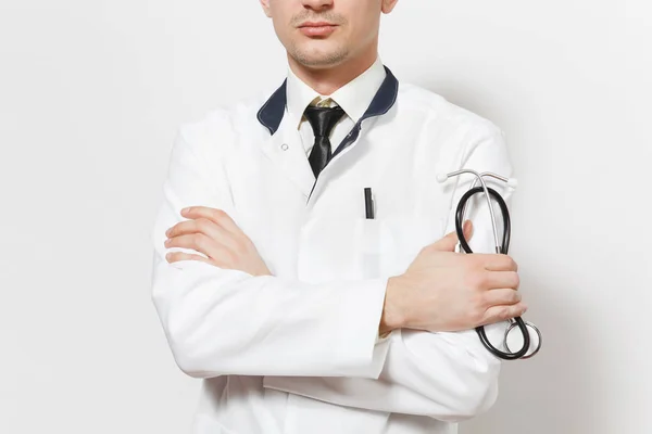Close up cropped shot young doctor man isolated on white background. Male doctor in medical uniform holding stethoscope, holding hands folded. Healthcare personnel health medicine concept. Copy space. — Stock Photo, Image