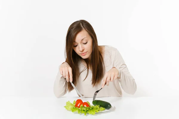 Vegan woman at table with leaves salad lettuce, vegetables on plate isolated on white background. Proper nutrition, vegetarian food, healthy lifestyle dieting concept. Advertising area with copy space Royalty Free Stock Images