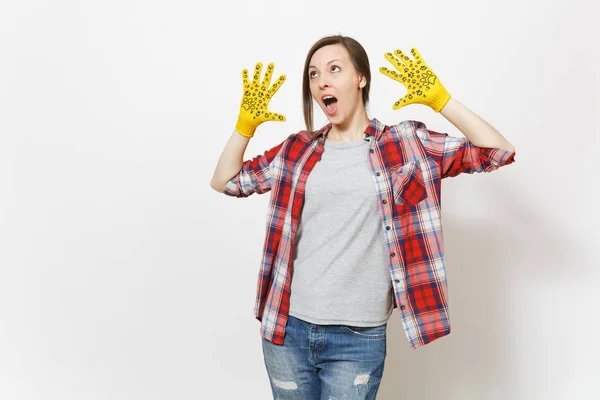 Young fun crazy beautiful woman showing hands in building yellow gloves with fun print isolated on white background. Accessories for renovation apartment room. Repair home concept. Advertising area.