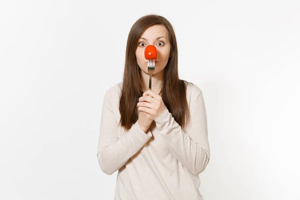 Donna che tiene il pomodoro fresco rosso sulla forchetta nel naso anteriore come clown isolato su sfondo bianco. Una corretta alimentazione, cibo vegetariano, stile di vita sano, concetto di verdura. Area pubblicitaria con spazio di copia . — Foto Stock
