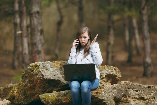 Young shocked business woman or student in casual clothes sittin