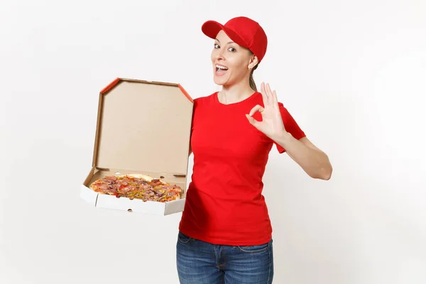 Delivery woman in red uniform isolated on white background. Pretty female in cap, t-shirt, jeans working as courier or dealer holding italian pizza in cardboard flatbox. Copy space for advertisement. — Stock Photo, Image