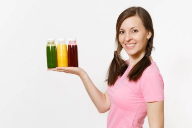 Eğlenceli kadın beyaz arka plan üzerinde izole şişe yeşil, kırmızı, sarı Detoks smoothies satır tutar. Doğru beslenme, vejetaryen içki, sağlıklı yaşam, diyet kavramı. Kopya alanı reklam için.