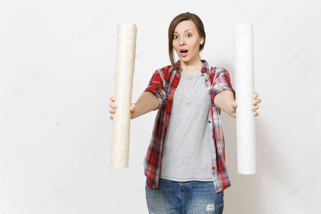 Young shocked beautiful woman in casual clothes showing wallpaper rolls on camera isolated on white background. Instruments, accessories, tools for renovation apartment room. Repair home concept.