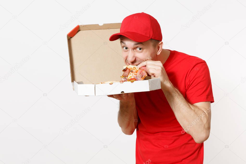 Delivery smiling man in red uniform isolated on white background. Male pizzaman in cap, t-shirt working as courier or dealer holding italian pizza in cardboard flatbox. Copy space for advertisement