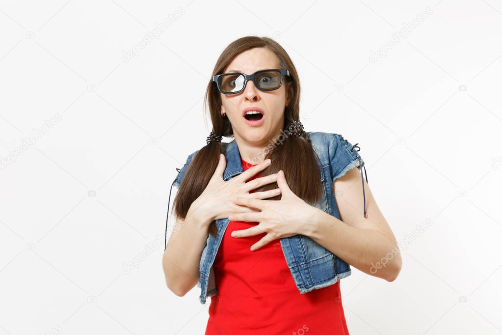 Portrait of young shocked scared attractive brunette woman in 3d glasses and casual clothes watching movie, film, clinging to chest isolated in studio on white background. Emotions in cinema concept