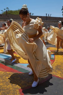 ARICA, CHILE - FEBRUARY 11, 2017: Group of dancers of Africa descent (Afrodescendiente) performing at the annual Carnaval Andino con la Fuerza del Sol in Arica, Chile. clipart