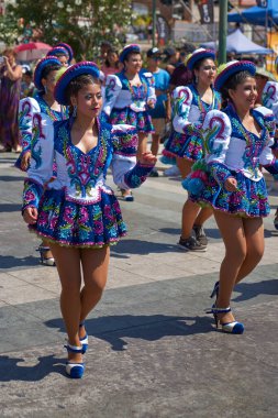 ARICA, CHILE - FEBRUARY 11, 2017: Caporales dancers in ornate costumes performing at the annual Carnaval Andino con la Fuerza del Sol in Arica, Chile. clipart