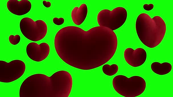 Rode fluwelen hartjes hangen in de lucht rond één groot hart op een groene achtergrond. Videolus — Stockvideo