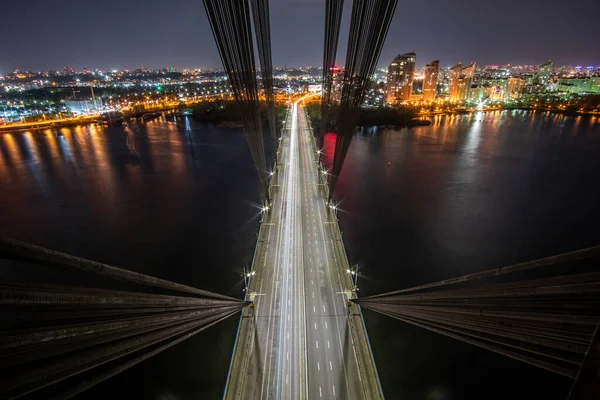 Aerial view of the bridge with the highway at night from the pylon of the cable-stayed bridge. View inside cable-stayed bridge.
