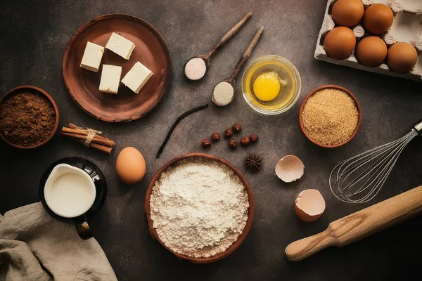 Baking background. A variety of ingredients for making chocolate cake, cookies and muffins. Top view, flat lay.