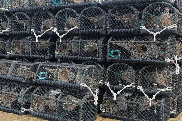 Lobster creels stacked on an English quayside — Stock Photo, Image