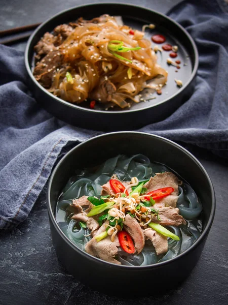 Asian Cuisine, Spicy Asian Beef Noodles and Pho bo on dark