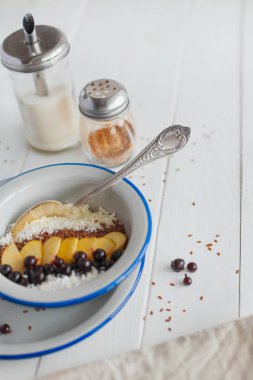 Beyaz arka planda kahvaltıda elmalı ve üzümlü Semolina lapası.