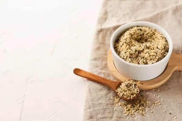 Cannabis Kernels White Bowl Wooden Spoon Linen Napkin White Table — Stock Photo, Image