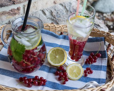 Ev yapımı ferahlatıcı limonata, buz ve limon ile kırmızı kuş üzümü