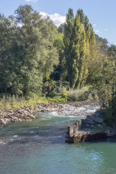 Mountain river in the forest. Landscape in France. Green tourism. Pitfalls in the river. Rapids for rafting. French way. Camino de Santiago. The way of the pilgrim. Camino Frances.