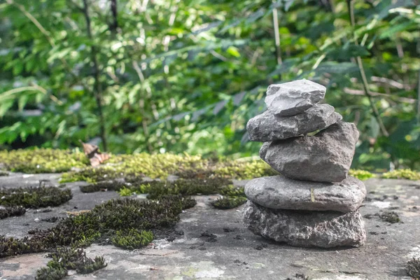 Balancing stones. The stone pyramid. Achieving calm. Stones on top of each other. Reaching Zen. Pile of pebbles. Memorable place. Symbol of harmony. Meditation and retreat in nature.