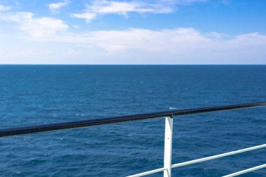 Dünya turu. Deniz gezisi. Feribotun yanından deniz manzarası. Sakin deniz. Gemideki tırabzanlar. Sakin mavi deniz.